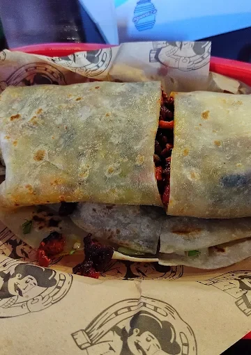A flavorful burrito at Tijuanazo Hipodromo, showcasing a soft tortilla stuffed with seasoned meat and fillings.