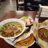 Beef soup dinner at Tijuanazo Hipodromo, accompanied by radishes and a taco.