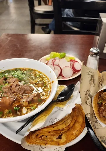 Beef soup dinner at Tijuanazo Hipodromo, accompanied by radishes and a taco.