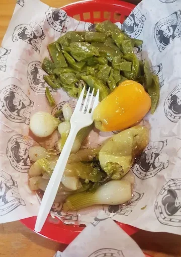 Grilled vegetables at Tijuanazo Hipodromo, featuring green peppers and onions.