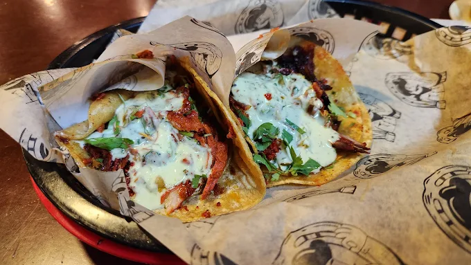 Delicious tacos at Tijuanazo Hipodromo, featuring various meats and fresh toppings.