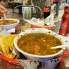 A hearty soup at Tijuanazo Hipodromo, paired with tortillas and refreshing beverages.