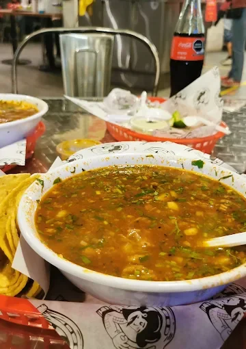 A hearty soup at Tijuanazo Hipodromo, paired with tortillas and refreshing beverages.
