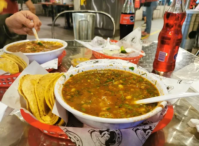 A hearty soup at Tijuanazo Hipodromo, paired with tortillas and refreshing beverages.