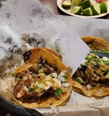 Tacos at Tijuanazo Hipodromo, featuring flavorful fillings and vibrant toppings, with lime on the side.